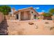 Desert backyard with a covered patio and stone landscaping at 2015 E Glenhaven Dr, Phoenix, AZ 85048