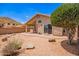 Backyard with covered patio, desert landscaping, and a privacy wall at 2015 E Glenhaven Dr, Phoenix, AZ 85048