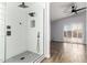 Renovated shower features a rainfall shower head, bench, and sleek glass enclosure at 2015 E Glenhaven Dr, Phoenix, AZ 85048