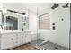 The bathroom includes a double sink vanity, sleek lighting, and a frameless glass shower at 2015 E Glenhaven Dr, Phoenix, AZ 85048