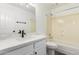 Bright bathroom featuring white cabinets, marble countertops, and shower-over-tub at 2015 E Glenhaven Dr, Phoenix, AZ 85048