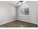 Bright bedroom features a large window and wood look tile flooring at 2015 E Glenhaven Dr, Phoenix, AZ 85048