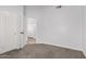 Carpeted bedroom shows large closet and open door to hallway and additional closet space at 2015 E Glenhaven Dr, Phoenix, AZ 85048