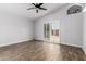 Spacious bedroom with a ceiling fan and sliding glass door to the backyard at 2015 E Glenhaven Dr, Phoenix, AZ 85048