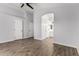 Large bedroom boasts wood-look flooring and an ensuite bathroom at 2015 E Glenhaven Dr, Phoenix, AZ 85048