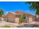 Charming single-story home features a terracotta tile roof, desert landscaping, and a two car garage at 2015 E Glenhaven Dr, Phoenix, AZ 85048
