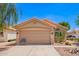 Charming single-story home features a terracotta tile roof, low maintenance desert landscaping, and a two car garage at 2015 E Glenhaven Dr, Phoenix, AZ 85048