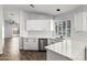 Updated kitchen with white cabinets, stainless steel appliances, and marble countertops at 2015 E Glenhaven Dr, Phoenix, AZ 85048
