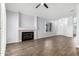 Inviting living room features a fireplace and wood look tile flooring at 2015 E Glenhaven Dr, Phoenix, AZ 85048