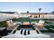 Spacious backyard featuring a modern fire pit, outdoor seating, putting green and manicured lawn at 2023 N 79Th Pl, Scottsdale, AZ 85257