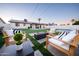 Beautiful backyard with a fire pit, lounge chairs, lush artificial grass, and a sparkling pool at 2023 N 79Th Pl, Scottsdale, AZ 85257