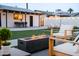 Relaxing backyard scene showcases a modern fire pit, pool, and lounge area under a string-lit sky at 2023 N 79Th Pl, Scottsdale, AZ 85257