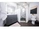 Modern bathroom featuring a glass-enclosed shower, contemporary vanity with gold hardware, and elegant marble tiling at 2023 N 79Th Pl, Scottsdale, AZ 85257