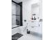Modern bathroom showcasing a sleek vanity and black-framed shower-tub combination with stylish fixtures at 2023 N 79Th Pl, Scottsdale, AZ 85257