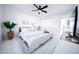 Airy bedroom featuring a comfortable bed, modern ceiling fan, a TV and white dresser, and stylish decor at 2023 N 79Th Pl, Scottsdale, AZ 85257