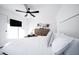 Bright bedroom with white walls, tile floors, and a comfortable bed with decorative pillows at 2023 N 79Th Pl, Scottsdale, AZ 85257