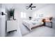 Inviting bedroom featuring white tile floors, light wood accents, and natural light from a large window at 2023 N 79Th Pl, Scottsdale, AZ 85257