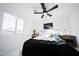 Bright bedroom featuring a ceiling fan, stylish decor, and a comfortable bed with decorative pillows at 2023 N 79Th Pl, Scottsdale, AZ 85257