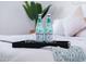 Close-up of a bedside tray with water bottles and glasses, adding a touch of hospitality to the cozy bedroom setting at 2023 N 79Th Pl, Scottsdale, AZ 85257