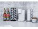 Stylish coffee station with modern machine, flavor syrups, k-cup carousel, and coffee mugs against decorative tile at 2023 N 79Th Pl, Scottsdale, AZ 85257