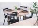 Modern dining area featuring a round table with place settings, including black plates, cutlery, and clear glassware at 2023 N 79Th Pl, Scottsdale, AZ 85257