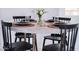 Elegant dining table set with black plates, woven placemats, and a floral centerpiece at 2023 N 79Th Pl, Scottsdale, AZ 85257