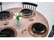 Modern dining table with round top, stylish black chairs, and sophisticated table setting at 2023 N 79Th Pl, Scottsdale, AZ 85257
