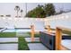 Backyard featuring modern fire pit, lounge chair, pool and lush landscaping creating a perfect oasis at 2023 N 79Th Pl, Scottsdale, AZ 85257