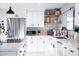 Modern kitchen featuring white cabinets, stainless steel appliances, and decorative open shelving at 2023 N 79Th Pl, Scottsdale, AZ 85257