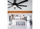 Bright kitchen featuring a central island, stylish pendant lighting, and stainless steel appliances with backyard view at 2023 N 79Th Pl, Scottsdale, AZ 85257
