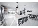 Open concept kitchen with white island, breakfast bar, and dining area at 2023 N 79Th Pl, Scottsdale, AZ 85257