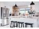 Bright kitchen features an island with seating, stainless steel appliances, and patterned backsplash at 2023 N 79Th Pl, Scottsdale, AZ 85257