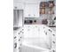 Well-lit white kitchen with stainless steel appliances and open shelving for decor at 2023 N 79Th Pl, Scottsdale, AZ 85257