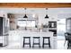 Modern kitchen featuring an island with seating, stainless steel appliances, and stylish tile backsplash at 2023 N 79Th Pl, Scottsdale, AZ 85257
