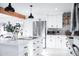 Bright white kitchen with stainless steel appliances and a center island at 2023 N 79Th Pl, Scottsdale, AZ 85257