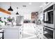Bright, white kitchen features modern appliances, an island, and eye-catching patterned backsplash at 2023 N 79Th Pl, Scottsdale, AZ 85257