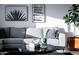 Bright living room featuring a gray sectional sofa, round coffee table, and contemporary artwork at 2023 N 79Th Pl, Scottsdale, AZ 85257