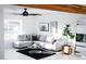 Sunlit living room with gray sectional sofa, black rug, and modern decor, showcasing a stylish and inviting space at 2023 N 79Th Pl, Scottsdale, AZ 85257
