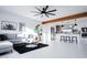 Stylish open-concept living room with gray sectional, modern decor, and seamlessly flowing into the modern kitchen at 2023 N 79Th Pl, Scottsdale, AZ 85257