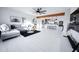 Open-concept living area features a gray sofa, modern decor, and a view into the adjacent stylish kitchen at 2023 N 79Th Pl, Scottsdale, AZ 85257