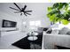 Well-lit living room with a comfortable sofa, large TV, and stylish decor for relaxation at 2023 N 79Th Pl, Scottsdale, AZ 85257