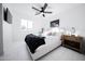 Bright bedroom with a ceiling fan, white bedding, and a mounted TV at 2023 N 79Th Pl, Scottsdale, AZ 85257