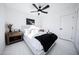 Bright bedroom with a ceiling fan, white bedding, and a mounted TV at 2023 N 79Th Pl, Scottsdale, AZ 85257
