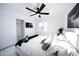 Bright bedroom with a ceiling fan, white bedding, and a mounted TV at 2023 N 79Th Pl, Scottsdale, AZ 85257