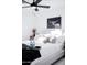 Bright bedroom features white bedding, a ceiling fan, and natural light from the window at 2023 N 79Th Pl, Scottsdale, AZ 85257