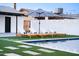 Beautiful in-ground pool with lounge chairs and an umbrella providing shade at 2023 N 79Th Pl, Scottsdale, AZ 85257