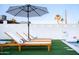 Poolside view of lounge chairs with umbrella, and a playful unicorn float at 2023 N 79Th Pl, Scottsdale, AZ 85257