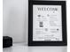 Close-up of a framed welcome sign listing the wifi, check-in/out times, contacts, house rules, and a request for reviews at 2023 N 79Th Pl, Scottsdale, AZ 85257