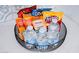 A black wire basket is filled with bottled water and prepackaged snacks on a white marble countertop at 2023 N 79Th Pl, Scottsdale, AZ 85257