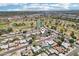 Aerial view showcasing the neighborhood, featuring a nearby golf course, ponds, and map pin at 207 E Strahan Dr, Tempe, AZ 85283
